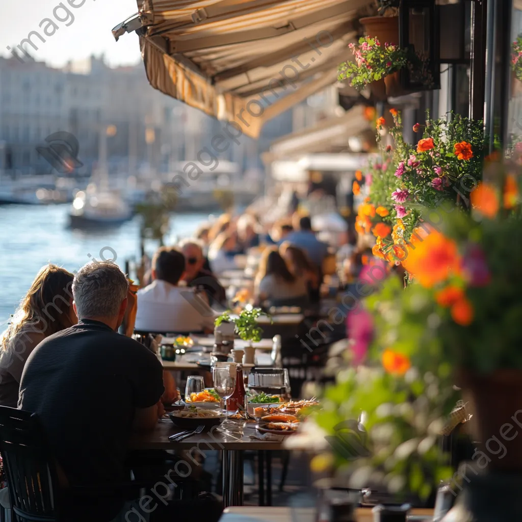 Patrons dining at a seaside café with a view of the harbor and flowers. - Image 4