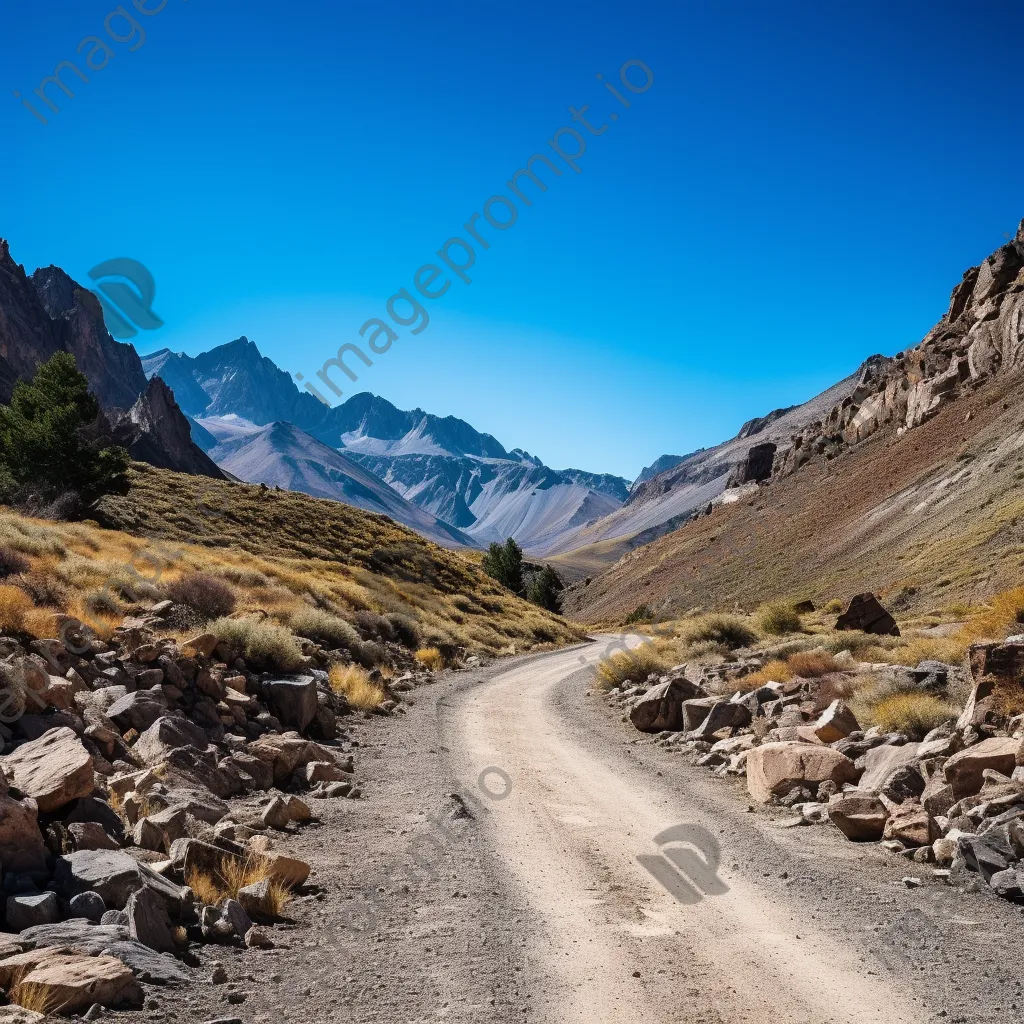 High-altitude mountain pass with gravel road and rock formations - Image 1