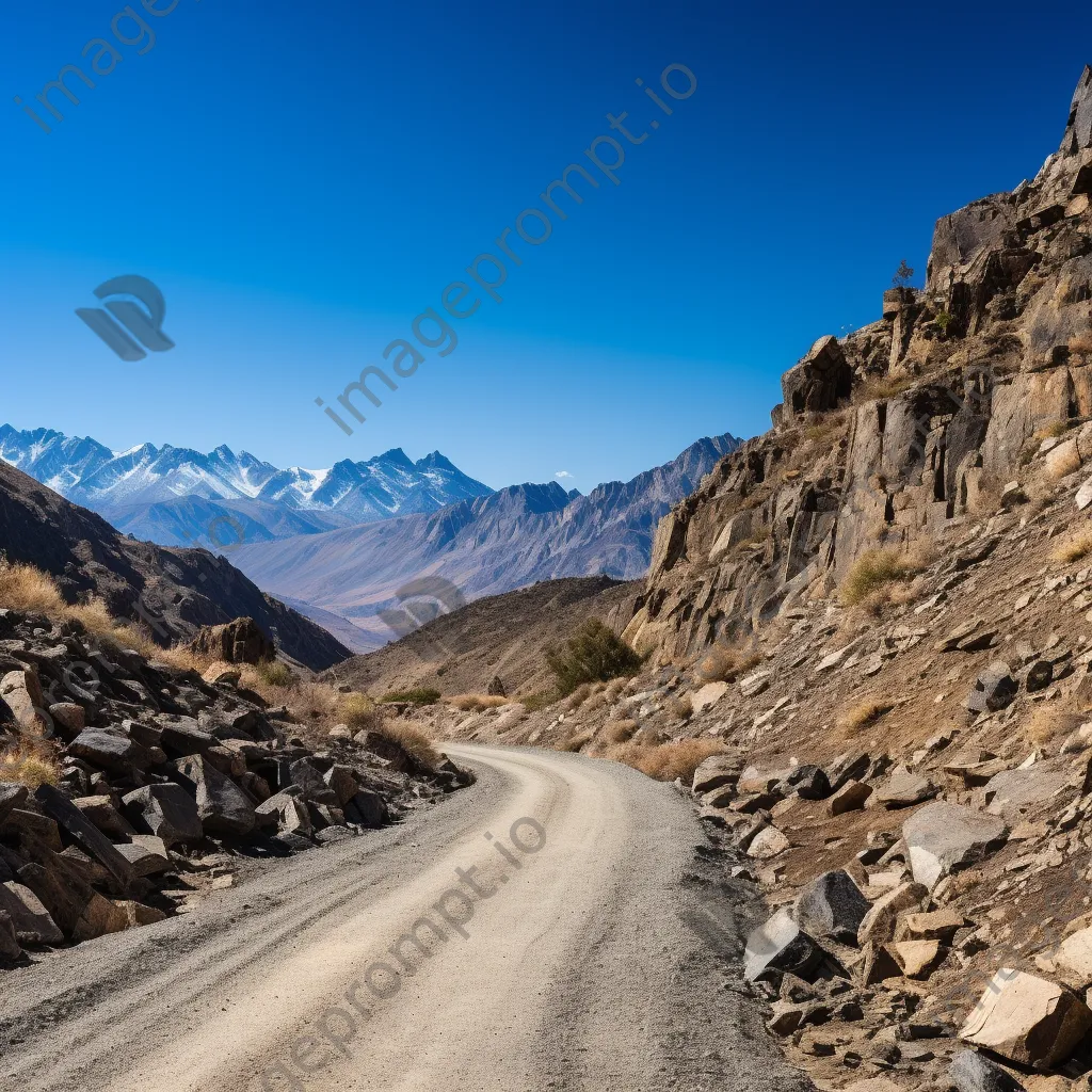 High-altitude mountain pass with gravel road and rock formations - Image 2