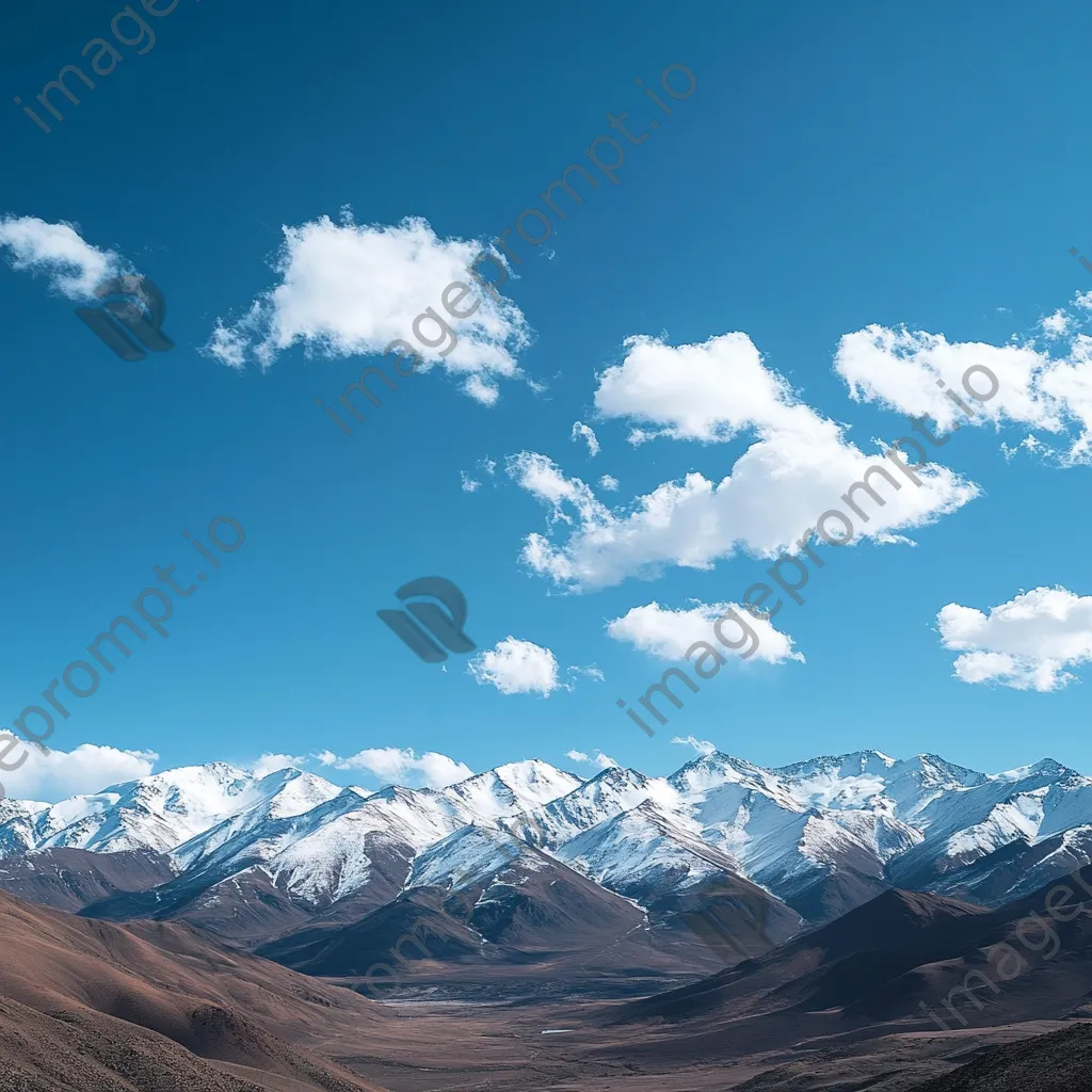 Panoramic view of snow-capped mountain ridges under blue sky - Image 2