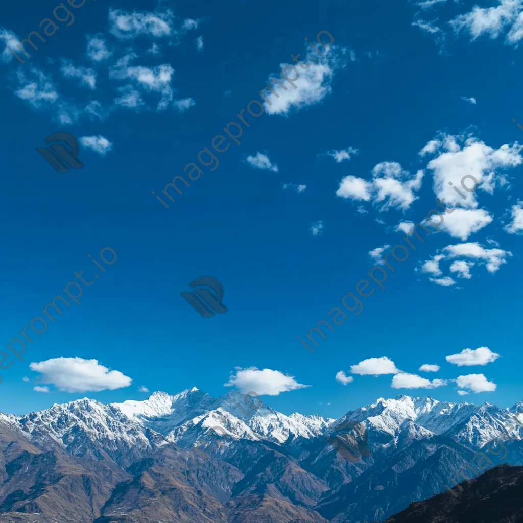 Panoramic view of snow-capped mountain ridges under blue sky - Image 4