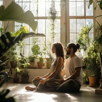 Couple doing partner yoga poses in a studio - Image 3