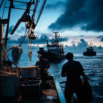 Fishermen checking equipment aboard a boat at dawn in a harbor. - Image 1