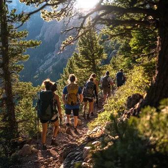 A diverse group of hikers on a steep mountain trail enjoying nature together. - Image 1