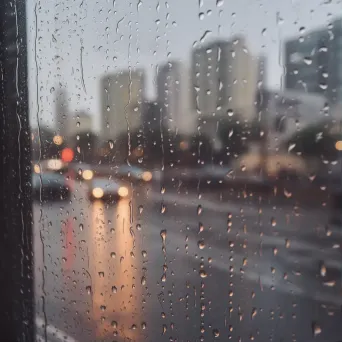 raindrops tracing lines on window - Image 1