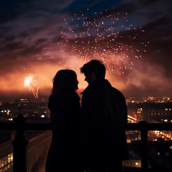 Couple silhouetted against the city skyline enjoying fireworks on New Year