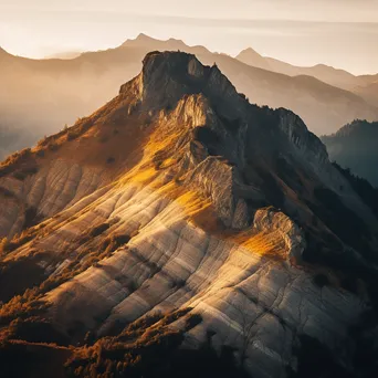 Sunrise over jagged mountain ridges with golden light - Image 2