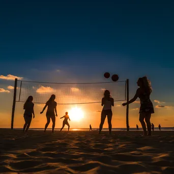 Friends playing beach volleyball at sunset - Image 2