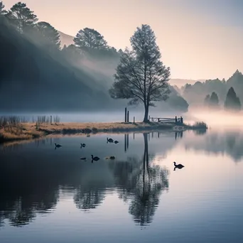 Black and white lakeside scene at dawn with mist rising from the water - Image 4