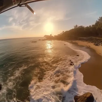 Coastline at sunrise with helicopters patrolling, aerial beach view - Image 1