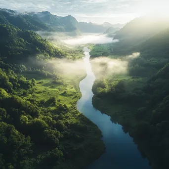 Winding river in a misty valley with greenery - Image 1