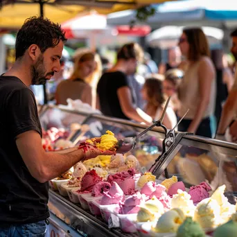 Artisan gelato vendor scooping gelato into cones at a local festival. - Image 3