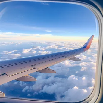 Clouds and landscape viewed through airplane window - Image 4