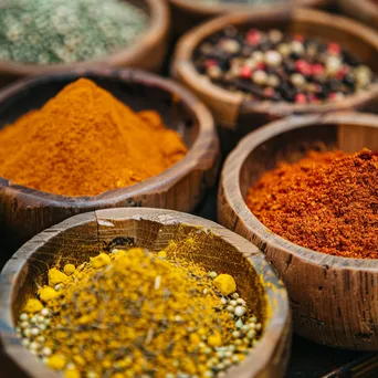 Close-up view of colorful spices in wooden bowls at a street market, lit by soft natural light. - Image 4