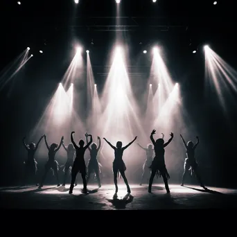 Group of dancers performing in harmony on stage. - Image 2