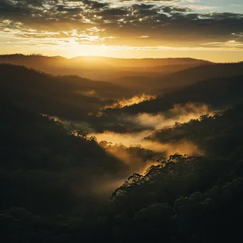 Golden hour light illuminating a misty valley - Image 1