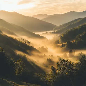 Golden hour light illuminating a misty valley - Image 3