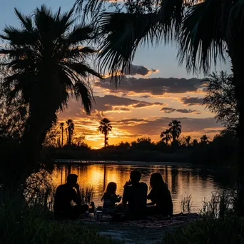 Family picnic by the oasis at sunset - Image 1
