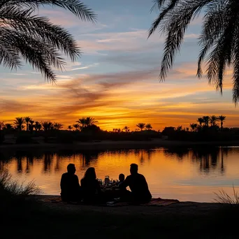 Family picnic by the oasis at sunset - Image 3