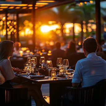 Upscale outdoor dining with guests and sunset lighting - Image 3