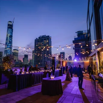 Elegant rooftop party with city skyline views and stylish lighting - Image 4