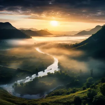 Misty mountain valley illuminated by first light at dawn - Image 3