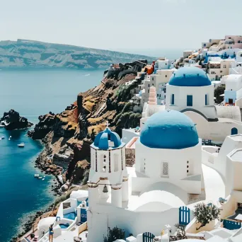 Santorini island with white buildings and blue domes - Image 1