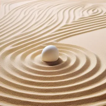 Image of a smooth pebble in the center of a Zen garden