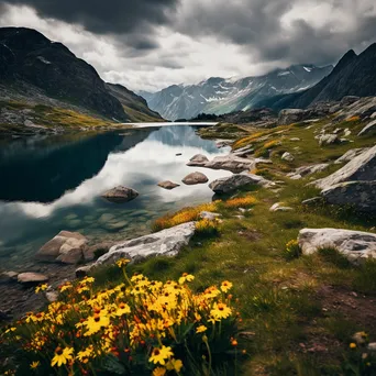 Alpine lake bordered by rocky cliffs and wildflowers in spring - Image 2