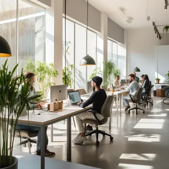 Individuals working in a bright, minimalist co-working space - Image 3