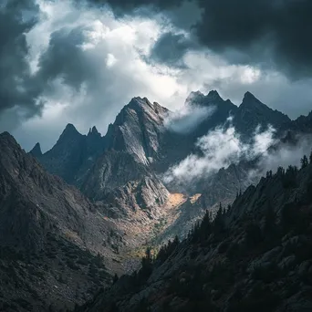 Rocky mountain ridges beneath dark storm clouds - Image 3