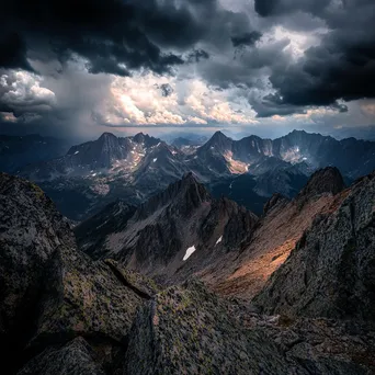 Rocky mountain ridges beneath dark storm clouds - Image 4