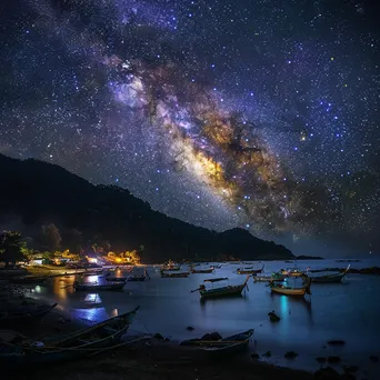 Milky Way over a quiet fishing village at night - Image 1