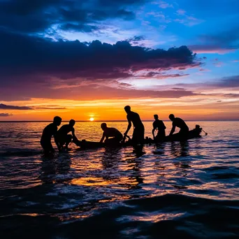 Silhouetted pearl divers against sunset sky - Image 2