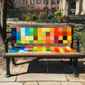 A wooden park bench painted to resemble vibrant pixel art - Image 3