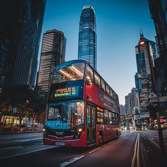 Double-decker bus passing iconic city landmarks against a clear sky. - Image 3