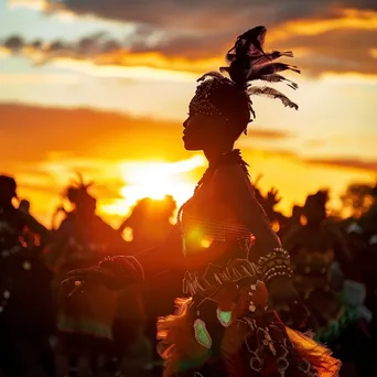 Performers in traditional attire dancing at sunset - Image 1