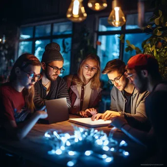 Group of creatives brainstorming at night with fairy lights - Image 3