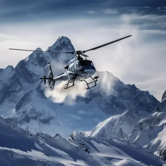 Mountain range in winter with helicopters hovering, aerial view - Image 1