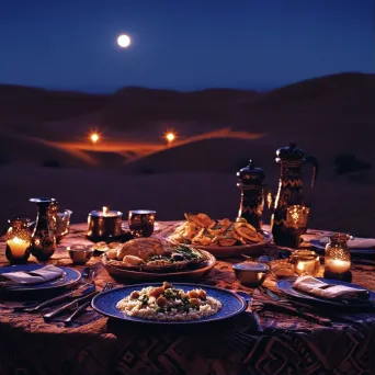 Lavish moonlit dinner spread in the Sahara desert with tagines and couscous - Image 1