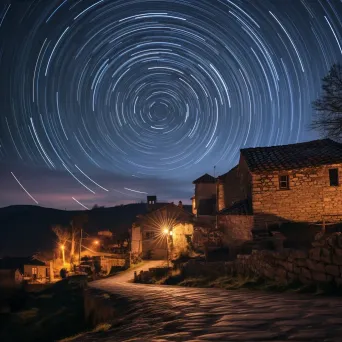 Star trails dancing above a quiet village with ancient stone cottages - Image 4