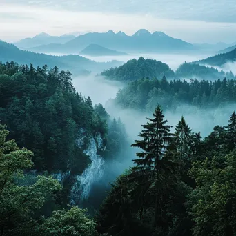 Misty mountain ridges partially obscured by fog - Image 2