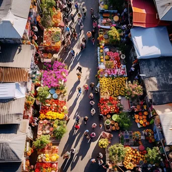 Overhead shot of a vibrant street market displaying fresh flowers and plants in various colors. - Image 3