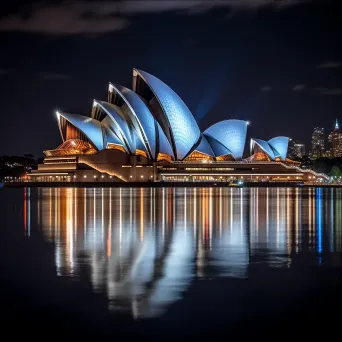 Sydney Opera House illuminated at night with reflection in Sydney Harbour - Image 3