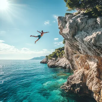 Athlete cliff diving into blue water - Image 2