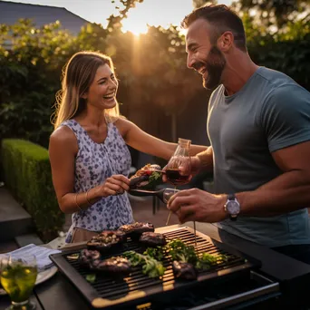 Couple grilling steaks outdoors with wine - Image 1