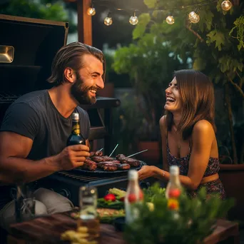 Couple grilling steaks outdoors with wine - Image 2