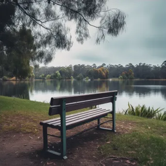 Lonely park bench by tranquil lake shot on Canon EOS R6 - Image 4