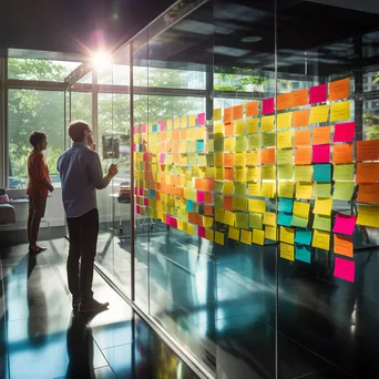 Colorful sticky notes on a glass wall in an office - Image 3