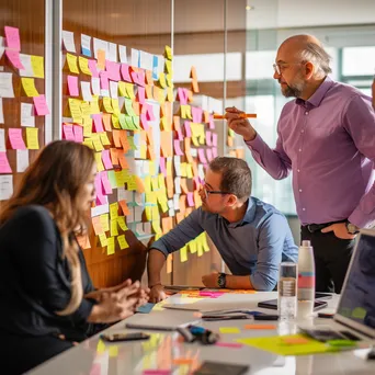 A creative team brainstorming in a conference room with sticky notes and a whiteboard. - Image 3